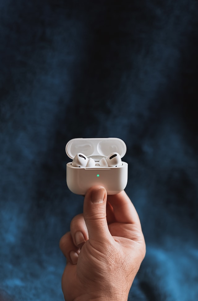 person holding airpods pro