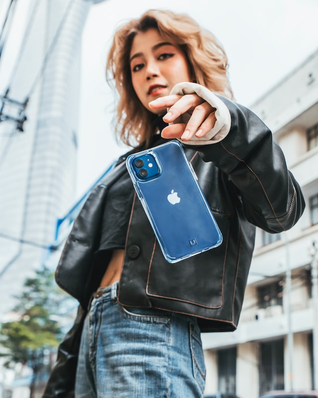 person holding blue iphone
