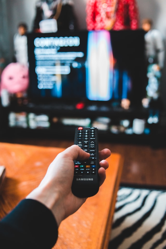 person holding remote tv control